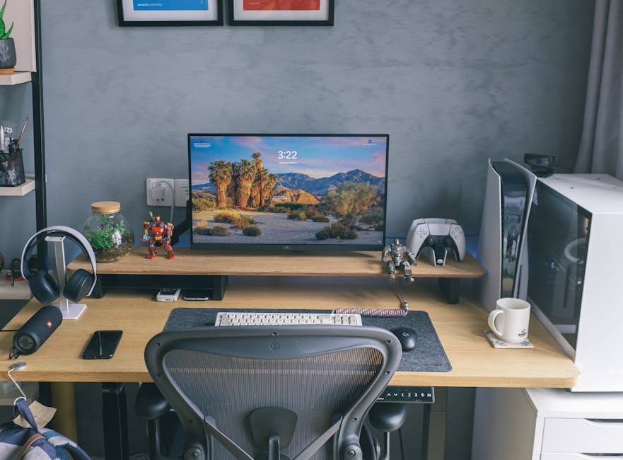 A contemporary home office desk featuring a computer setup with gaming peripherals and decor.