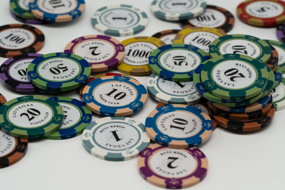 Close-up of colorful Las Vegas poker chips scattered on a table.