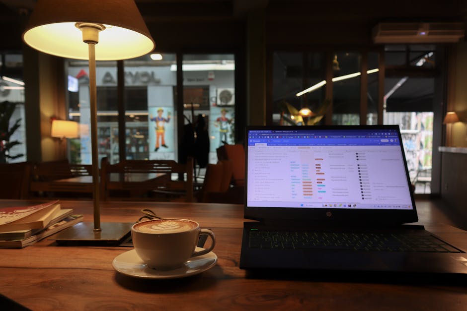 Relaxing café scene in Istanbul featuring a cappuccino and laptop on a wooden table.