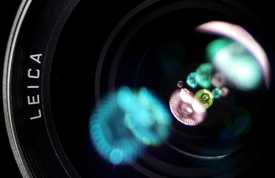 Detailed view of a camera lens showing light reflections and selective focus for photography enthusiasts.