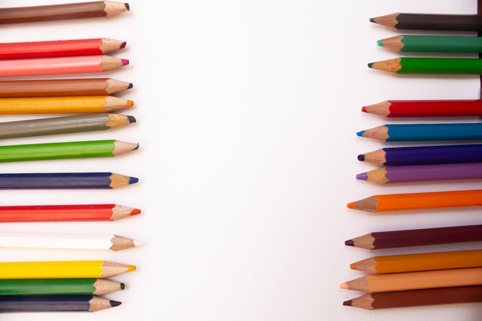 Diagonal arrangement of colorful pencils on a white background with ample copy space.