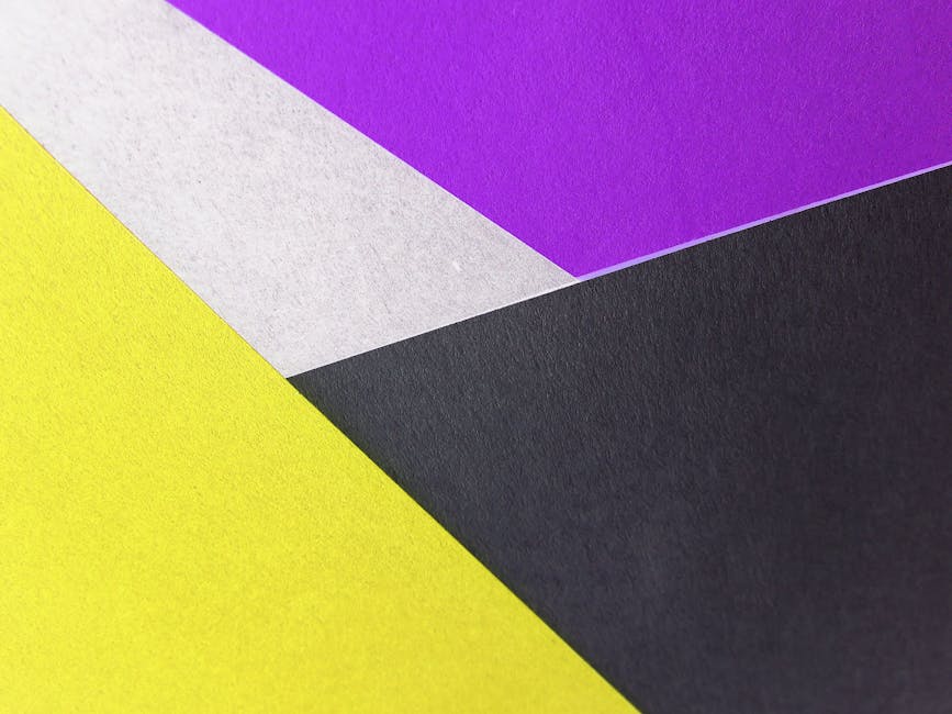 Vibrant geometric composition with yellow, purple, black, and white paper textures.