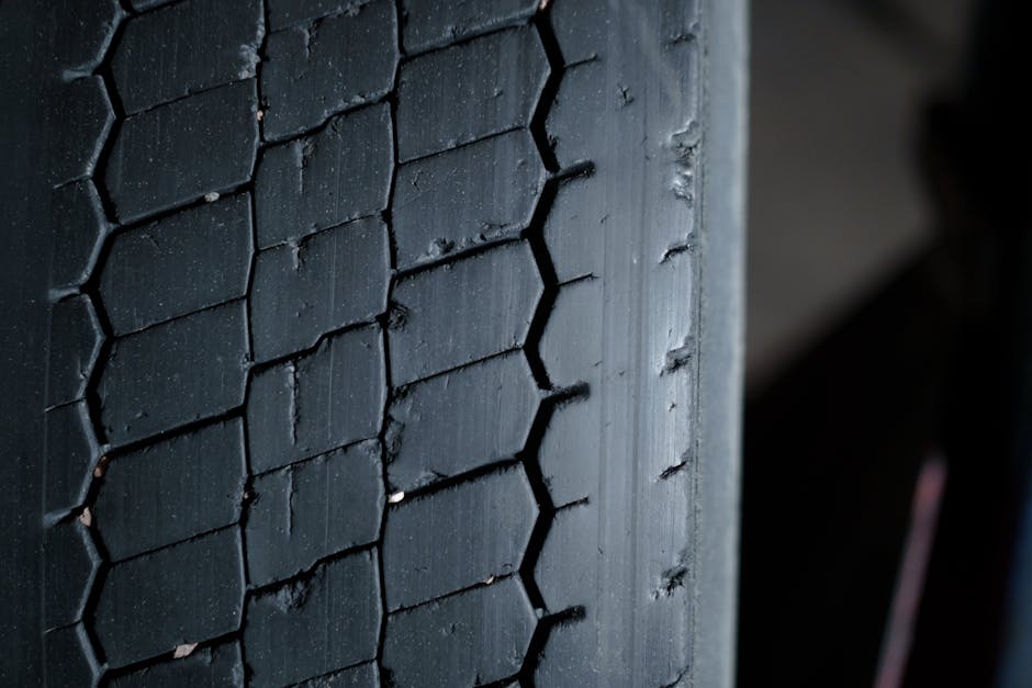 Detailed close-up of a worn tire tread showcasing grooves and patterns.