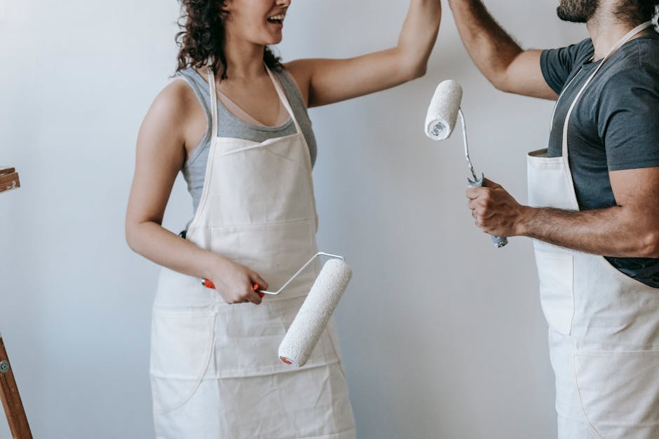 A joyful couple high-fiving during a home renovation project. Modern and casual lifestyle scene.