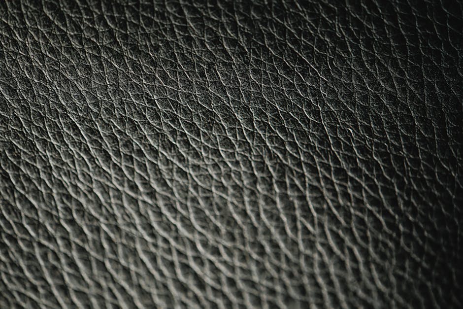 Macro photograph showcasing the intricate texture and pattern of black leather.