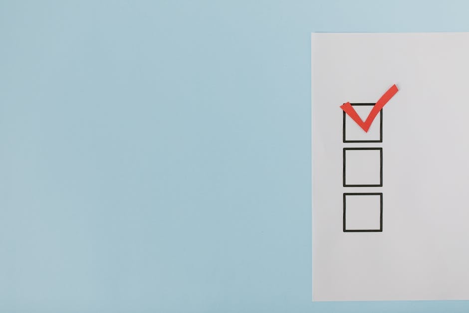 A minimalist checklist with a red checkmark on a blue background, providing ample copy space.